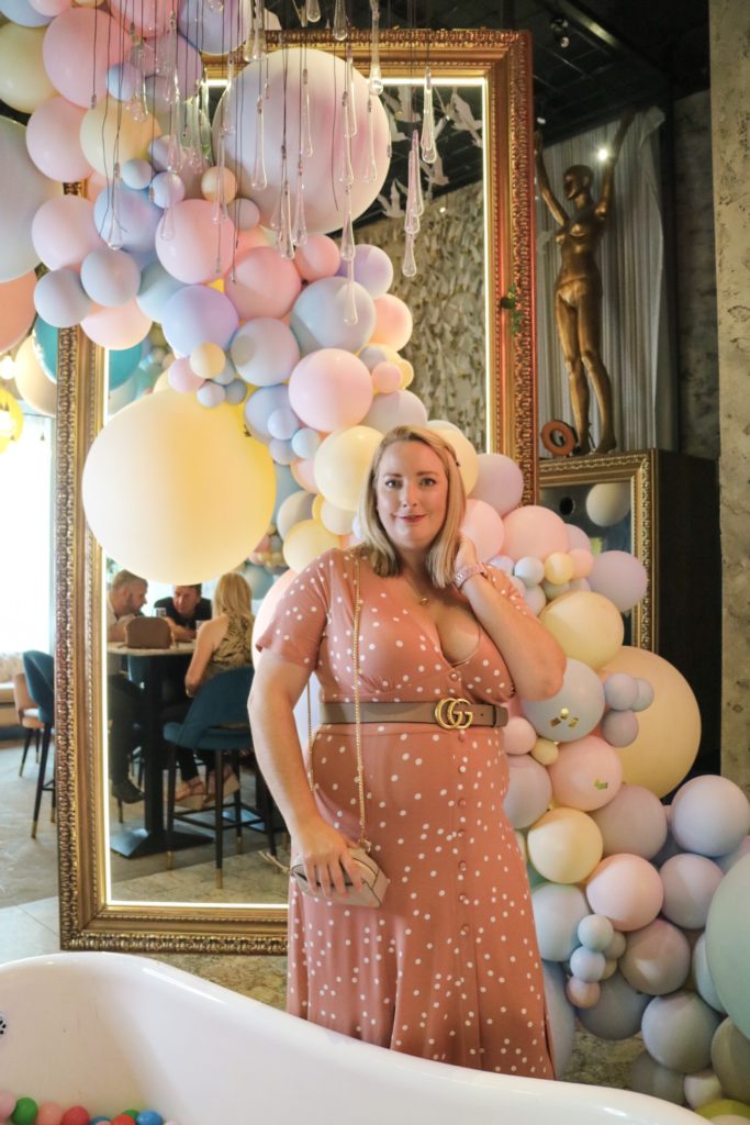 lucy stoof in front of balloons in menagerie manchester