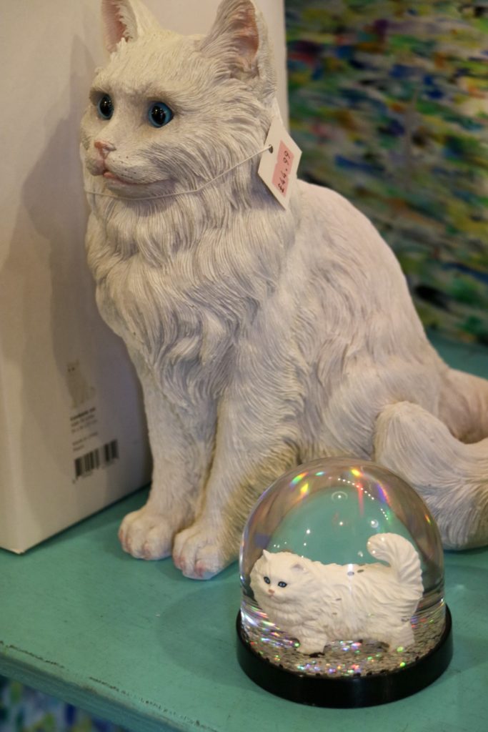 a cat money box and glitter globe
