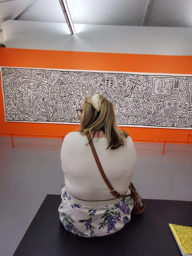 lcy looking at pieces of art from the Keith Haring exhibition at the Tate Liverpool