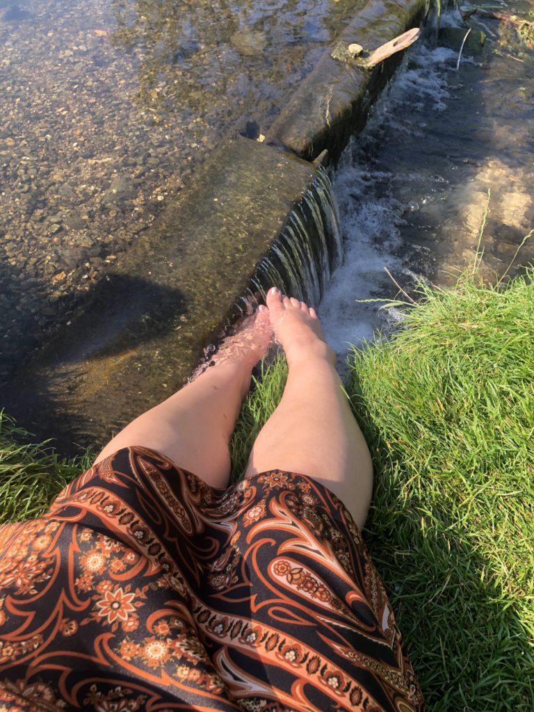 lucy dipping her toes in the stream