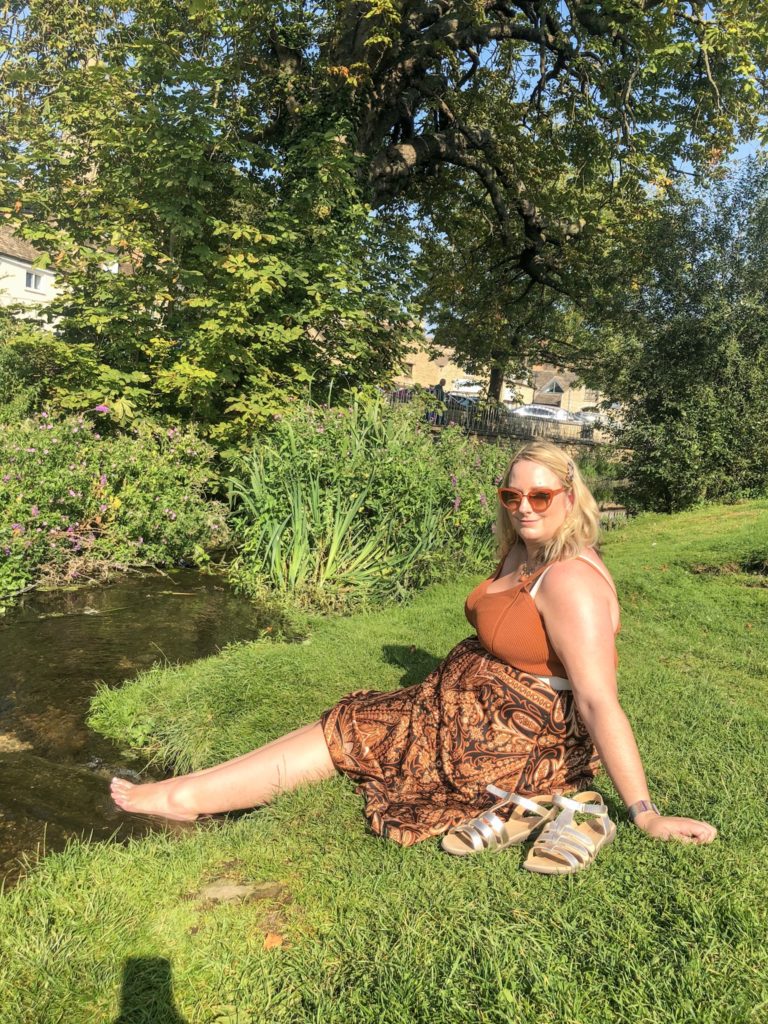 lucy dipping her toes in the stream