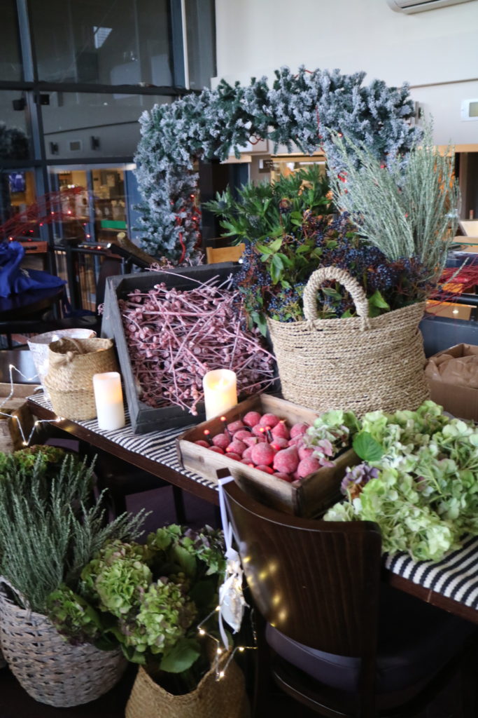 baskets and boxes filled with foliage and flowers to make the wreaths